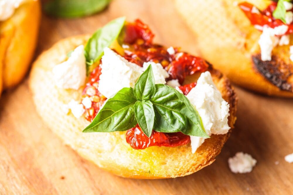 Crostini With Cherry Tomatoes, Feta Cheese, Garlic, And Fresh Basil ...